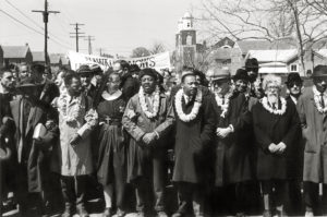 Matt Herron Selma-Montgomery, Alabama 3/21/1965March leaders (wearing leis) prepare to leave Selma at the start of the third march. From left to right: John Lewis, a nun, Ralph Abernathy, Martin Luther King, Ralph Bunche, and Rabbi Abraham Joshua Heschel.